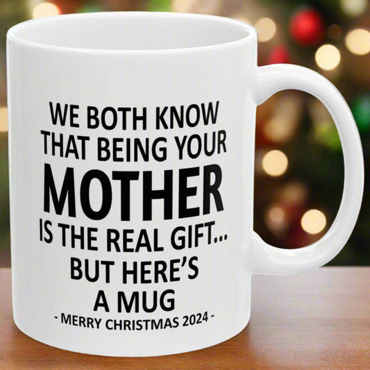 We Both Know That Being Your Mother Is The Real Gift, But Here's A Mug, Funny Christmas 2024 Gift Coffee Mugs 11oz