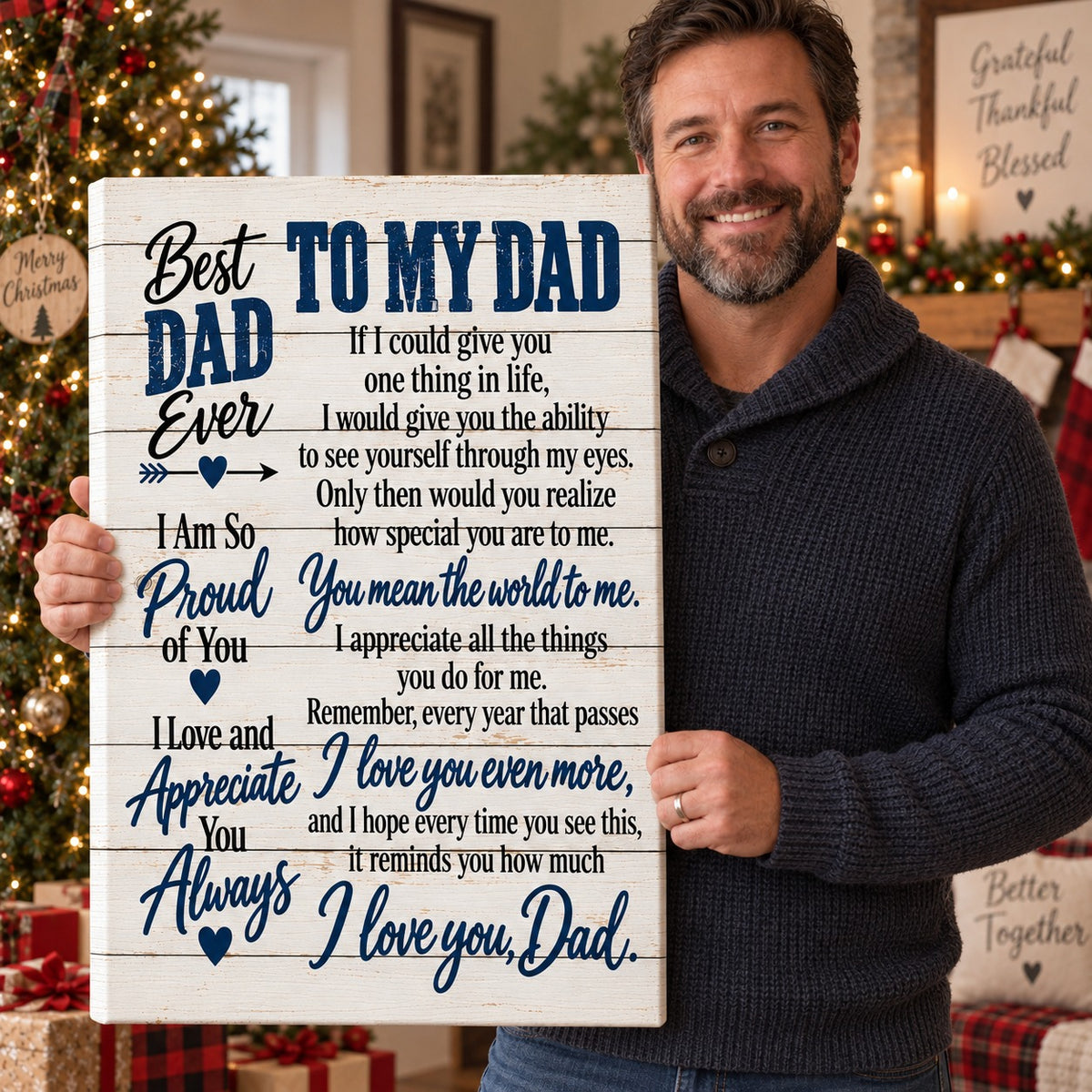 Dad holding To My Dad canvas by the Christmas tree